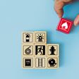 Hand choose cube wooden block stack with fire icon and door exit sing or fire escape with prevent icon and fire extinguisher and emergency prevention or protection symbol for safety and rescue.
