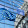 European Union flags in front of the blurred European Parliament in Brussels, Belgium